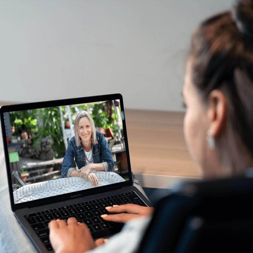 Laptop watching Miriam mockup - smallest file - in canva FFFT woman celebrating with raised arms in front of a large burning hamster wheel