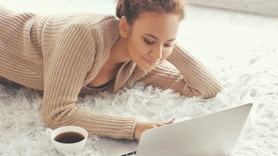 woman celebrating with raised arms in front of a large burning hamster wheel